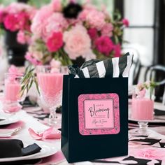 a table set with pink and black decorations