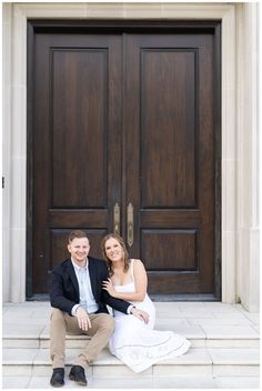 a man and woman sitting on the steps in front of a door with their arms around each other