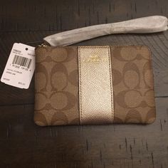 Brown Coach Wristlet New With Tags And Unused, The Front Has A Gold Metallic Detail Down The Middle. Coach Gold Wristlet For Everyday Use, Gold Coach Wristlet For Everyday, Coach Gold Clutch Wristlet, Coach Gold Rectangular Wristlet, Gold Coach Clutch Wristlet, Gold Rectangular Coach Wristlet, Elegant Gold Coach Wristlet, Gold Rectangular Wristlet With Wrist Strap, Leopard Print Boots