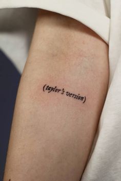 a person with a tattoo on their arm that says taylor's version in cursive writing