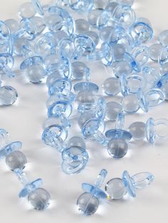 blue glass beads are scattered on a white surface