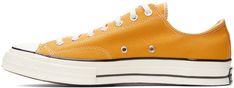 Low-top canvas sneakers in yellow. · Round rubber cap toe · Lace-up closure in white · Eyelet vents at inner side · Rubber sole featuring rubberized logo patch at heel Supplier color: Sunflower/Black/Egret Retro Yellow High-top Sneakers With Rubber Sole, Yellow Converse Canvas Sneakers, Yellow High-top Sneakers With Rubber Toe Cap, Retro Yellow Sneakers With Vulcanized Sole, Yellow Canvas High-top Sneakers With Vulcanized Sole, Yellow High-top Cotton Sneakers, Vintage Yellow Sneakers For Streetwear, Yellow Cotton High-top Sneakers, Sporty Yellow Sneakers