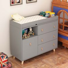 a baby's room with a crib and dresser