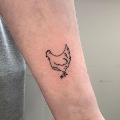 a small black hen tattoo on the left inner arm and wrist, it looks like an outline