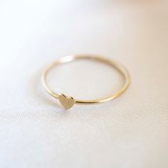 Our handmade 14k Gold Filled Heart Stacker will be a new staple in your ring collection. Simply wear it on it's own or stack together with other rings. Material: 14k Gold Filled Approximately 2mm in thickness. Minimalist Heart Shaped Stackable Promise Rings, Minimalist Rings With Heart Charm For Everyday, Minimalist Stackable Rings With Heart Charm For Promise, Minimalist Heart Charm Ring For Everyday, Minimalist Heart Charm Ring For Everyday Wear, Minimalist Everyday Ring With Heart Charm, Minimalist Midi Rings With Heart Charm For Promise, Minimalist Everyday Heart Ring With Charm, Minimalist Midi Rings With Heart Charm For Wedding