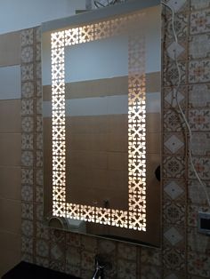 a bathroom mirror that is reflecting the light in it's reflection on the wall