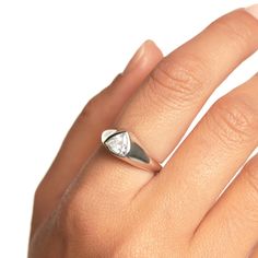 a woman's hand with a diamond ring on it