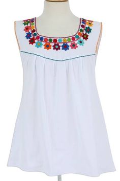 This carefree snow white cotton sleeveless blouse gathers at the yoke creating a breezy silhouette with a little bit of swing. Handcrafted by Mexican artisan Manuela Gomez the cotton fabric is handwoven on a traditional backstrap loom. Colorful hand embroidered flowers and circles ring the neckline and hand embroidered accent stitches in a variety of colors line the arm and neck openings and the where the yoke meets the body of the blouse. Cotton Sleeveless Blouse, Embroidered Duvet Cover, Embroidered Wedding Dress, Colorful Embroidery, Embroidered Napkins, Hand Embroidered Flowers, Embroidery Cotton, Embroidered Gifts, Embroidered Shoes