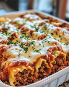 lasagna casserole with meat and cheese in a white dish on a table