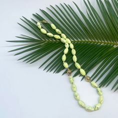 This bright lemon chrysoprase beaded necklace is a celebration of this beautiful light green stone. It is strung with two of our signature crownwork® finials and finished with an 18k yellow gold lilypad clasp. This one of a kind piece looks great layered with other necklaces or worn as a statement on its own. MATERIAL: 18k Yellow Gold STONE TYPE: Lemon Chrysoprase DIMENSIONS: 20" Elegant Green Oval Bead Necklaces, Elegant Green Necklaces With Oval Beads, Elegant Green Oval Beaded Necklaces, Elegant Green Necklace For Beach, Elegant Green Jewelry For Beach, Elegant Green Jewelry For The Beach, Elegant Green Beach Jewelry, Green Oval Single Strand Jewelry, Green Oval Beaded Jewelry