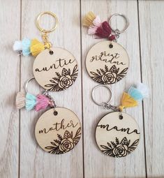 three wooden keychains with tassels on them that say, best mom