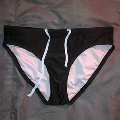 Size Small Champion Bikini Bottoms With A Tie-Able Waist Band. Never Worn Black Beachwear Swim Trunks For Pool, Black Stretch Swimwear With Tie-side Bottom, Black Stretch Tie-side Swimwear Bottom, Casual Black Tie-side Swimwear Bottom, Black Swim Trunks For Poolside And Beach Season, Black Fitted Tie-side Swimwear Bottom, Fitted Swim Trunks For Water Polo, Fitted Brief Swim Trunks For Water Polo, Fitted Water Polo Swim Trunks Brief