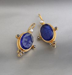 Description Gemstone} - Indigo Blue Glass Metal} - BRASS Gemstone Size - 13X18 mm Earring Height Including Hoop - 4.5 cm Earring Width - 2.5 cm Finish - Smooth and high polished with brilliant shine. {Note} -The earrings are made to order, production day is about 3-5 working days. The one you receive may be slight different from the one in the picture due to handmade nature, but it will be almost same as in the above picture.These pieces are handcrafted from start to finish and have an imperfect handmade look.These earrings are the perfect addition to your collection. Our rings are meant to be classic enough for everyday wear or to give as a bridesmaid gift. Natural stones may vary slightly in shape, size and color.Handmade Item You will receive the same piece as in the picture or identica Blue Pendant Earrings For Wedding, Blue Gemstone Pendant Earrings, Blue Pendant Earrings For Gift, Blue Round Clip-on Jewelry, Blue Oval Earrings For Wedding, Sapphire Single Earring For Gift, Sapphire Single Earring As Gift, Blue Clip-on Earrings For Gift, Blue Clip-on Earrings For A Gift