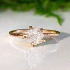 a white diamond ring sitting on top of a table