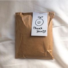 a brown bag with a thank you note attached to it