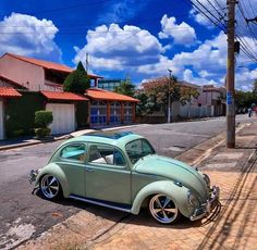 an old car is parked on the side of the road