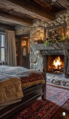 a bedroom with a stone fireplace in the corner and a rug on the floor next to it