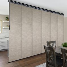 a dining room with a table and chairs next to a sliding glass door