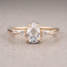 an oval cut diamond ring with three smaller diamonds on the band and side stones around it