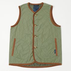 a green vest with brown trims and buttons on the front, sitting on a white surface