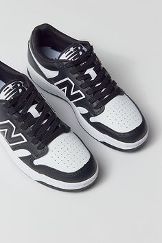 Classically cool New Balance Court 480 sneakers inspired by old-school basketball styles. Retro low-profile silhouette in premium paneled leather with perforated detailing. Lace-up style with a super cushy Ortholite insole and durable rubber soles. Features Retro-cool New Balance Court 480 sneakers Basketball-inspired for a slam-dunk look Comfy Ortholite insoles Lace-up style Content + Care Leather, rubber Spot clean Imported | New Balance 480 Court Sneaker in White/Black, Women's at Urban Outfi Men’s Sneakers, New Balance Sneakers Mens, New Balance For Men, New Balance 480, Men Shoes Casual, New Balance Mens, Profile Silhouette, School Basketball, Men's Shoes Accessories