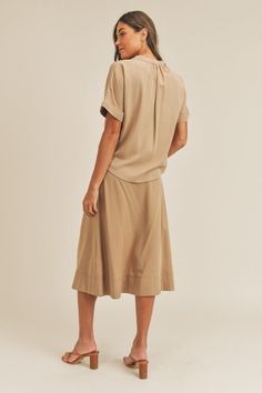 The Short Sleeve Top and Button-Down Midi Skirt Set delivers a stylish, coordinated look. The relaxed top pairs with an elegant button-down midi skirt for a classic touch. Versatile and easy to style, this set transitions effortlessly from day to night. Material composition: 70% tencel, 30% rayon Recommended sizing 2-4 S, 6 M, 8-10 L Product measurements: S:Bust 33-35 in, Waist 25-27 in, Hip 35-37 in M:Bust 35-38 in, Waist 27-30 in, Hip 37-40 in L:Bust 38-40 in, Waist 30-32 in, Hip 40-42 in Versatile Midi Length Skirt For Day Out, Relaxed Viscose Skirt For Day Out, Versatile Knee-length Midi Dress For Work, Short Sleeve Rayon Midi Dress For Work, Midi Length Rayon Skirt For Day Out, Viscose Midi Skirt For Workwear, Rayon Midi Skirt For Day Out, Casual Midi Dress With Button Cuffs For Work, Casual Dresses With Relaxed Skirt For Work