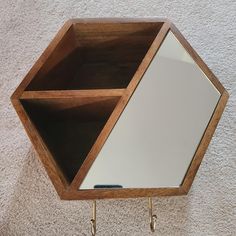 a mirror and shelf on the wall in a room with carpeted flooring,