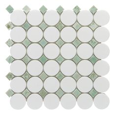 a white and green mosaic tile with dots on it's sides, in the shape of circles