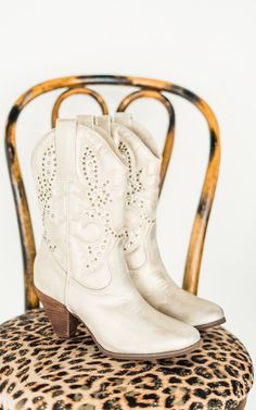 Bring the spirit of the Wild West into the modern era with these crisp champagne cowboy boots. Perfect for festivals, nights out, or even a quick line dance in the living room—because why not? Details Chic western inspired boot Faux leather upper in a crisp champagne hue with bronze studs Almond toe 3 inch heel height Fit true to size. If between sizes, size up. Brand: Naughty Monkey Colored Boots, 3 Inch Heels, Judy Blue Jeans, Jewelry Bags, Business Fashion, Shoe Box, Western Boots, Sale Items, Sneaker Boots