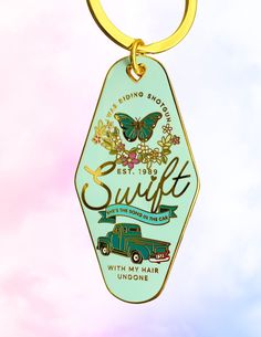 a green keychain with an image of a truck and butterfly on it