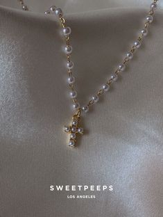 Product Details + Care - 18K Gold Dipped Over Brass - Brass: Copper + Zinc Alloy - 1 Necklace - Wipe Clean - Imported Dimensions - Chain is approximately 16" Have a question? Please message info@shopsweetpeeps.com and our support team will get back to you in 48 hours. Pearl Drop Cross Necklace Gift, Pearl White Cross Necklace Gift, White Pearl Cross Necklace Gift, White Pearl Cross Necklace As Gift, Gold Cross Jewelry With Pearl Charm, Gold Cross Necklace With Pearl Drop, Dainty White Cross Necklace, Pearl Cross Necklace, Cross Gold