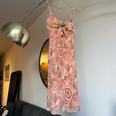 Vintage 90/00's silk paisley floral dress.  So cute with adjustable tie detail at the bust which is super flattering on the chest.  Size 4 and best for an xs/small.  Was very tight in my chest area and I am a small/medium.  100% silk outer with polyester lining.  I am 5'4 for reference! Silk Fitted Dress With Tie Straps, Fitted Silk Dresses With Tie Straps, Spring Silk Dress With Tie Straps, Fitted Silk Dress With Paisley Print, Spring Silk Dresses With Tie Straps, Silk Dresses With Tie Straps For Spring, Fitted Paisley Print Midi Dress For Beach, Vintage Fitted Dress With Tie Straps, Summer Silk Dress With Paisley Print