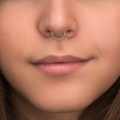 a woman with a nose ring on her nose