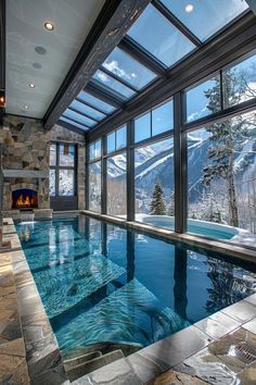 an indoor swimming pool in the middle of a room with large windows on both sides