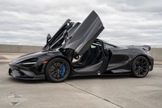 a black sports car with its doors open