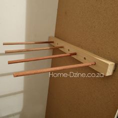 three wooden sticks are hanging on the wall