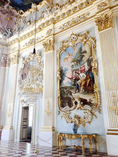 an ornately decorated room with paintings on the walls