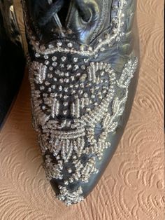 Here is an absolutely gorgeous pair of beaded black Victorian leather boots made by Marshall Fields & Co. Chicago. The toe box is adorned with rich, glittering glass beading that wraps around the sides. They show very little wear as if they were only worn once. As with most Victorian boots, they are quite small and very narrow: Toe to heel measure = 9 inches; ball of foot = 2 1/2 inches. It is certainly rare to find a pair of boots from this era in such magnificent shape. Designer Rhinestone Boots For Formal Events, Designer Rhinestone Boots For Formal Occasions, Designer Rhinestone Formal Boots, Designer Embellished Evening Boots, Elegant Evening Boots With Sequins, Elegant Sequined Boots For Evening, Elegant Bedazzled Evening Boots, Elegant Evening Bedazzled Boots, Elegant Leather Boots With Bling