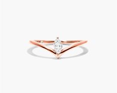 14K Rose Gold Marquise Cut Diamond Pinnacle Ring. The twinkle of the diamond complements the effortless style of the band. Wear this ring to shine like a star in the sky. Celestial Style Rose Gold Diamond Ring, Timeless Rose Gold Stackable Rings With Single Diamond, Formal Rose Gold Stackable Ring With Diamond, Timeless Rose Gold Solitaire Stackable Rings, Timeless Rose Gold Diamond Ring With Tension Setting, Timeless Solitaire Stackable Rings In Rose Gold, Timeless Rose Gold Halo Diamond Ring, 14k Rose Gold Ring With Single Diamond, Marquise Rose Gold Ring With Diamond Accents