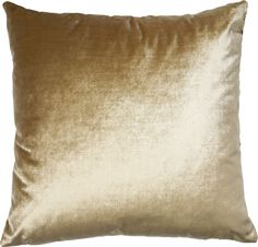 a gold velvet pillow on a white background