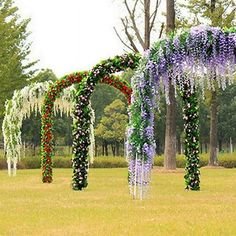 an outdoor wedding setup with flowers and greenery on the grass in front of trees