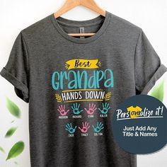 a t - shirt with the words best grandpa hands down and hand prints on it