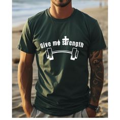 Elevate your workout wardrobe with our "Give Me Strength" Inspirational Workout T-Shirt in green. This tee is perfect for those who find their strength in both faith and fitness. Made from a comfortable blend of cotton and polyester, it ensures durability and breathability during your most intense workouts. Whether you're lifting weights or hitting the treadmill, this shirt will keep you motivated and focused. Key Features: 1. Inspirational "Give Me Strength" design 2. Comfortable cotton-polyester blend 3. Breathable and lightweight 4. Durable fabric perfect for workouts 5. Available in multiple sizes 6. Machine washable 7. Ideal for gym, yoga, and casual wear 8. Motivational message for fitness enthusiasts 9. Soft and stretchy for maximum comfort 10. Green color for a fresh, vibrant look Green Athleisure T-shirt For Workout, Green Crew Neck T-shirt For Athleisure, Green Crew Neck T-shirt For Gym, Green Workout T-shirt Short Sleeve, Green Sports T-shirt With Letter Print, Green Crew Neck Activewear For Gym, Green Graphic Tee For Workout, Green Graphic Print T-shirt For Workout, Green Letter Print T-shirt For Gym