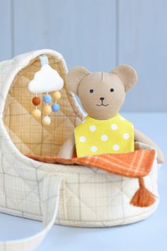 a teddy bear sitting in a baby carriage