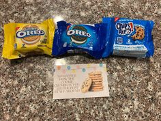 three bags of oreo cookies sitting on top of a counter