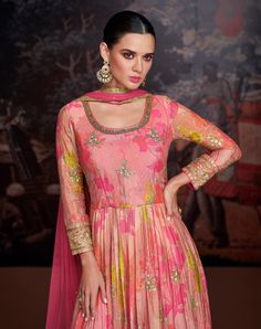 COLOR : Coral Pink FABRIC : Gown - Pure Georgette, Bottom - Mixed Fabric, Dupatta - Net WORK : Resham Embroidery, Zari Motifs, Floral Print, Sequins, Gota Patti, Lace BorderOCCASION : Wedding, Reception, Mehendi, Engagement, Party Wear, Festival READY-TO-WEAR : No STITCHING : Available as semi-stitched fabric, can be stitched using standard size option (+$20). Note: There might be a slight color variation due to lighting and flash used during photoshoot. The bright shade seen is the best closer Pink Anarkali Gown, Mehendi Function, Anarkali Suits Bollywood, Pink Anarkali, Celana Fashion, Gown With Dupatta, Rent Dresses, Georgette Tops, Anarkali Gown