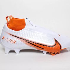 an orange and white soccer shoe with the word vapor written on the bottom part of it