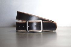 We take pride in making belts.  We use the highest quality leather to deliver an outstanding product that will last decades.  All of our Leather Belts are cut from FULL GRAIN, 9 oz., Veg tanned Double shoulders.  Our Vintage belts are distressed and antiqued to give each piece a unique finish.  These belts have a snap enclosure, so changing out buckles is simple and quick.  We also make our leather belts with 7 holes for optimum sizing for a sure fit.  Belts are 1.5" wide.Sizing is easy.  Simply Everyday Black Leather Belt Buckles, Everyday Black Leather Belt Buckle, Black Rectangular Leather Belt Buckles, Black Leather Rectangular Belt Buckles, Rectangular Leather Belt Buckles For Everyday Use, Classic Distressed Brown Leather Belt Buckle, Classic Distressed Brown Leather Belt Buckles, Vintage Rectangular Leather Belt Buckles, Classic Leather Belt Buckle In Distressed Brown