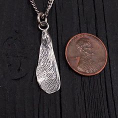 "Symbolic of rebirth and new relationships, a perfect silver maple key, cast directly from a real seed with every detail captured in sterling. Finished on all sides, it measures 1-1/16\" long not including the generous fixed bail on top." Nature-inspired Leaf Jewelry For Everyday, Everyday Nature-inspired Leaf Jewelry, Untreated Nature-inspired Pendant Jewelry, Button Studs, Key Pendant Necklace, Key Pendant, Jewelry Tree, Hand Cast, White Gift Boxes