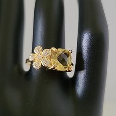 Main Stone: Natural Unheated Yellow Lemon Quartz W/ Cubic Zirconia Metal: 18k Yellow Gold Plated Over .925 Sterling Silver Measurements: Jewelry 8.4 X 16.3mm Gemstone 8.1 X 8.1 - 1.1 Mm Ring Size: 6.75 Formal Cubic Zirconia Flower Ring With Gemstone, Yellow Jewelry With Center Stone For Anniversary, Dazzling Yellow Rings For Gifts, Yellow Cubic Zirconia Ring For Anniversary, Formal Yellow Gold Flower Ring With Cubic Zirconia, Anniversary Flower Ring With Cubic Zirconia Gemstone, Elegant Yellow Crystal Ring With Gemstone, Gold Topaz Ring With Cubic Zirconia Accent Stones, Gift Yellow Gold Topaz Ring With Cubic Zirconia